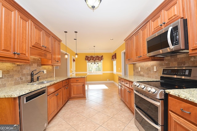 kitchen with sink, kitchen peninsula, pendant lighting, stainless steel appliances, and light stone countertops