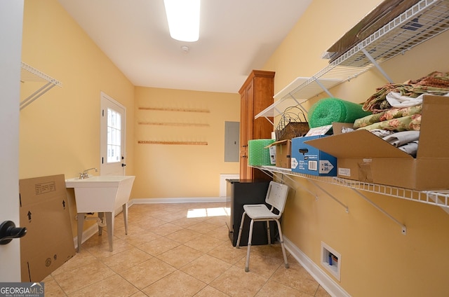 laundry area with cabinets, washer hookup, electric panel, and light tile patterned floors