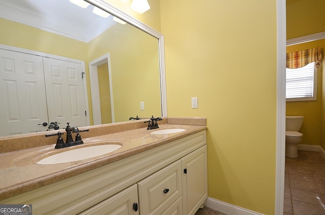 bathroom with vanity, tile patterned floors, ornamental molding, and toilet