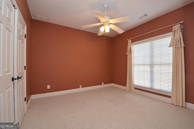 carpeted empty room with ceiling fan