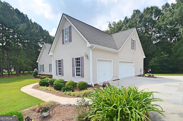 view of home's exterior with a garage and a lawn