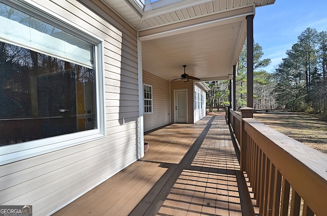 wooden terrace featuring ceiling fan