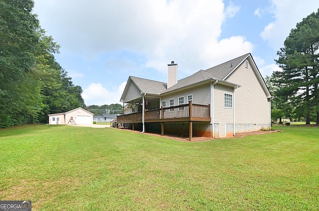 back of property featuring a garage, a deck, and a lawn