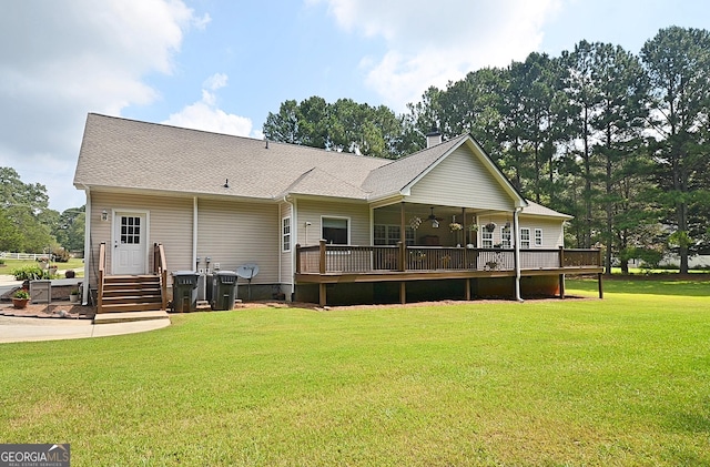 rear view of house featuring a lawn