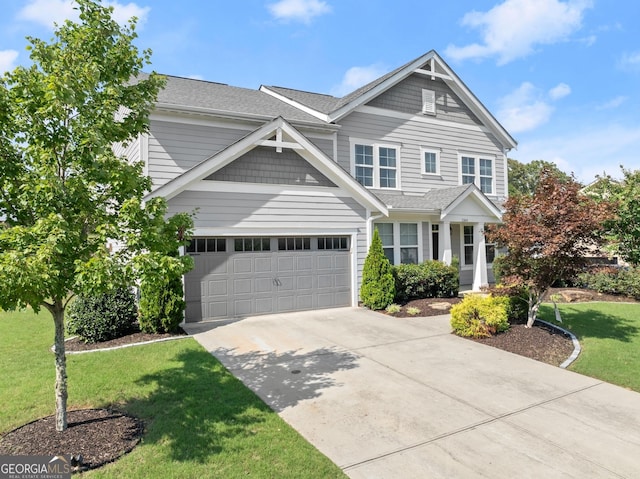 view of front of property with a garage and a front yard