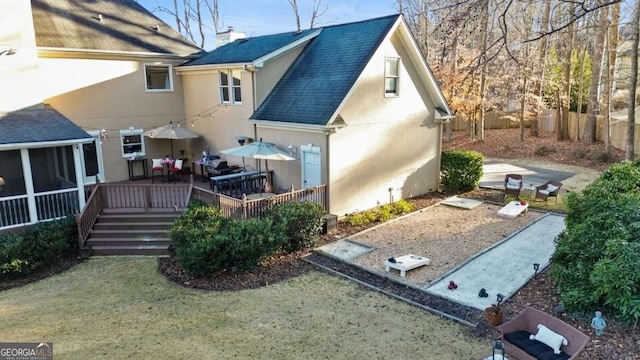 rear view of house with a wooden deck