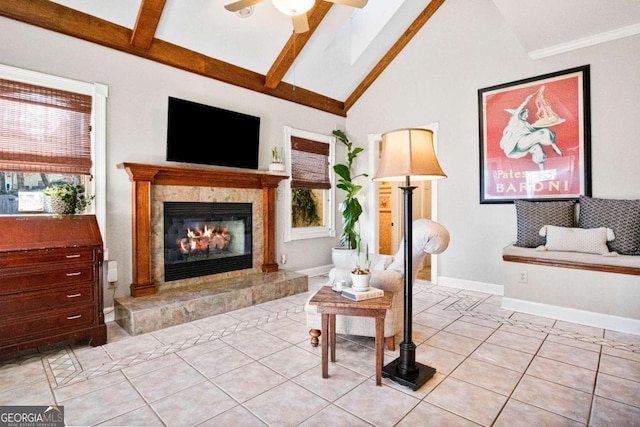 living area featuring lofted ceiling with beams, a healthy amount of sunlight, and light tile patterned floors