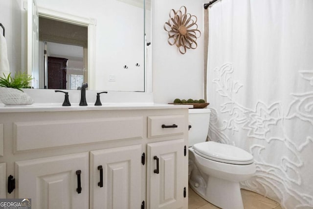 bathroom featuring tile patterned floors, vanity, and toilet