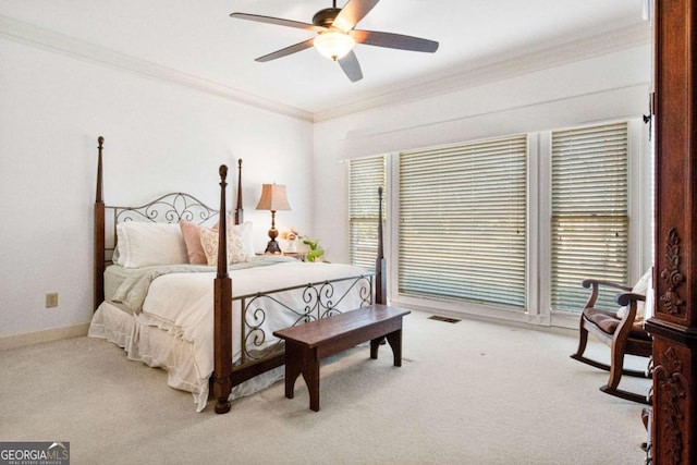 bedroom with light carpet, ornamental molding, and ceiling fan