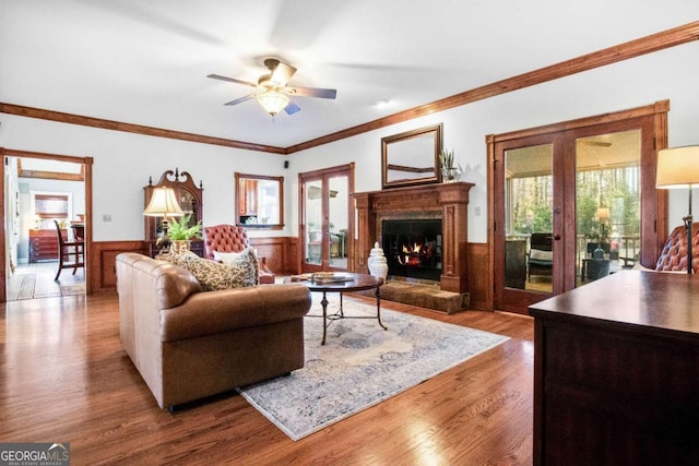 living room featuring crown molding, hardwood / wood-style flooring, french doors, and ceiling fan