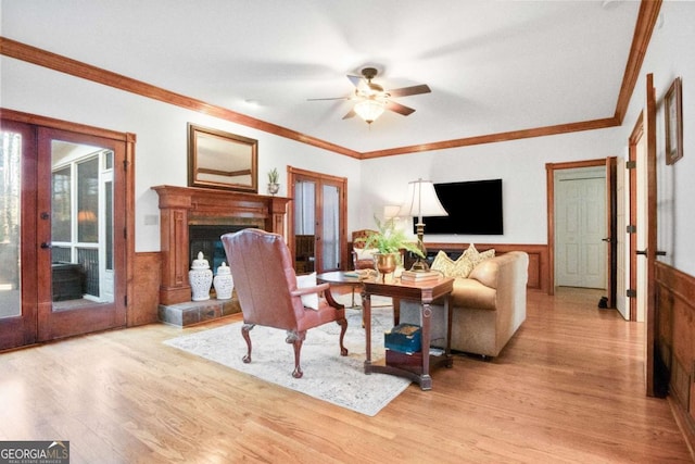 living room with french doors, ceiling fan, crown molding, and light hardwood / wood-style floors