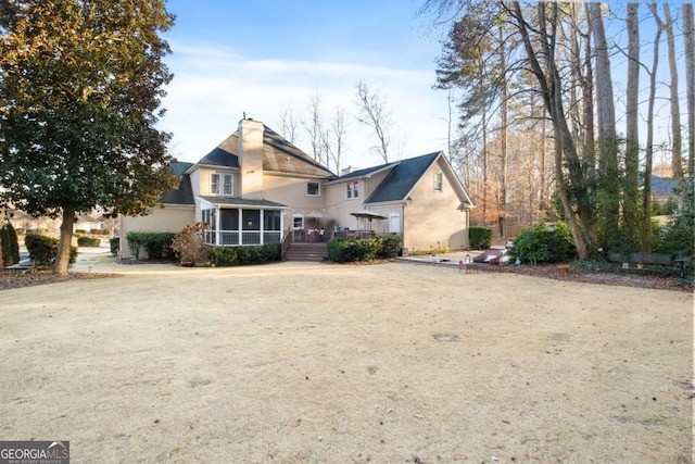 exterior space featuring a yard and a sunroom