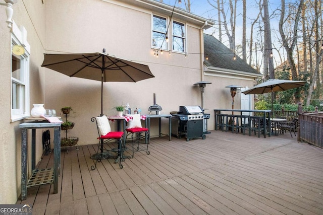 wooden deck with a grill