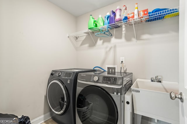 washroom featuring sink and washer and dryer