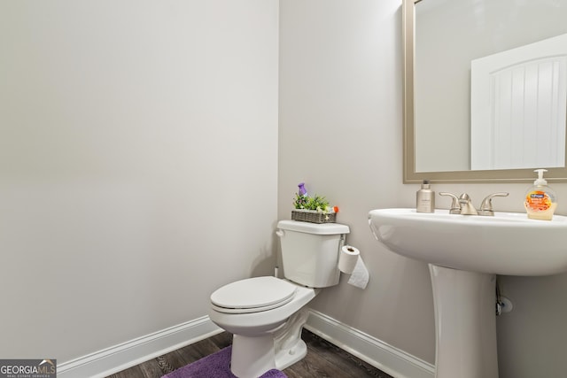 bathroom featuring hardwood / wood-style flooring and toilet