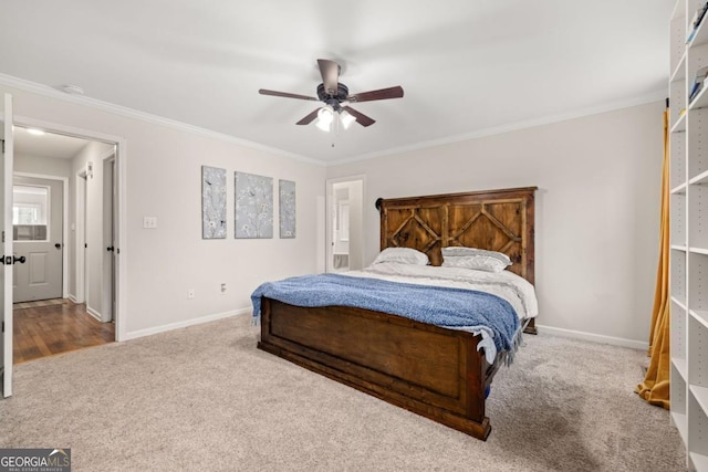 carpeted bedroom with ornamental molding and ceiling fan