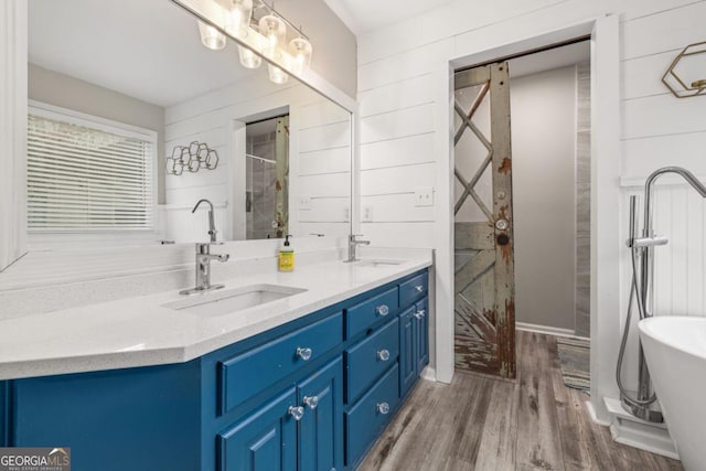 bathroom with vanity, hardwood / wood-style flooring, shower with separate bathtub, and wood walls