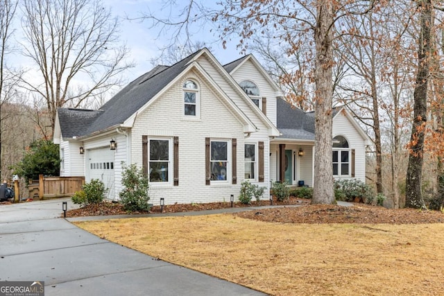 front facade with a garage and a front lawn