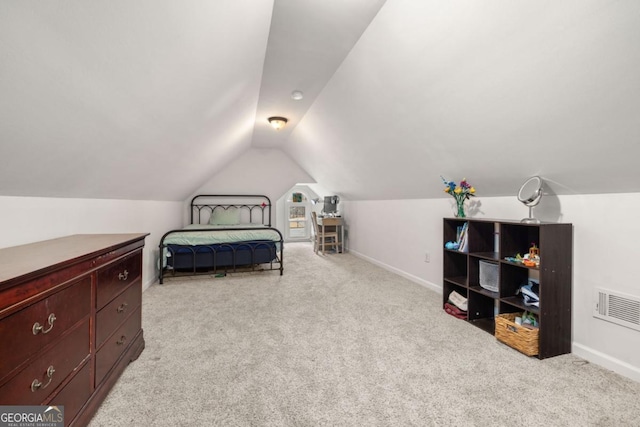 carpeted bedroom featuring lofted ceiling