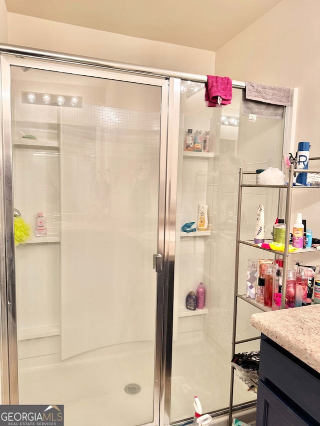 bathroom with vanity and walk in shower