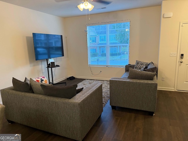 living room featuring dark hardwood / wood-style floors and ceiling fan