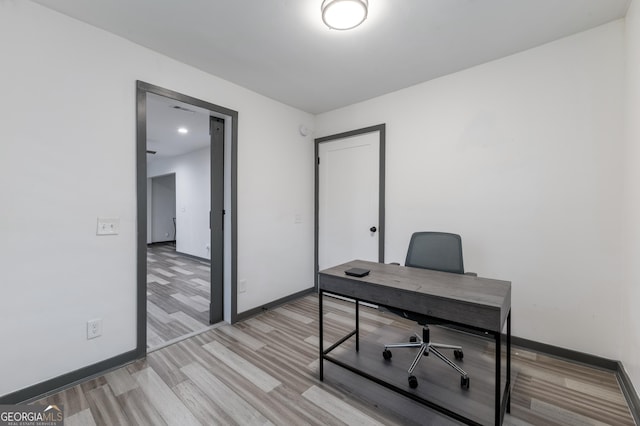 office space with light wood-type flooring