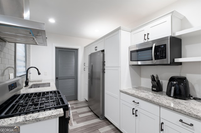 kitchen featuring white cabinetry, stainless steel appliances, sink, and island range hood