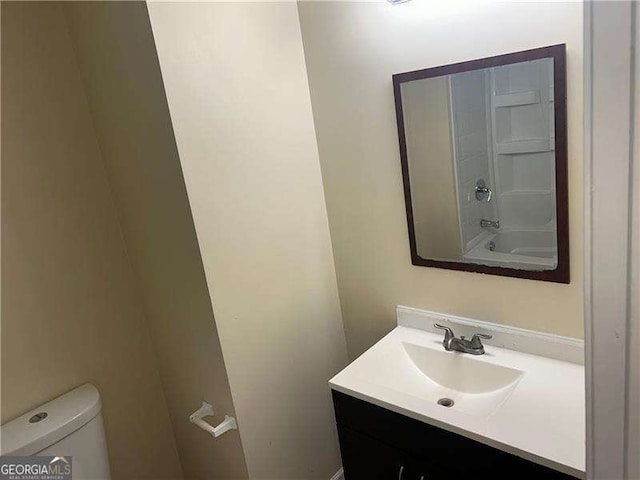 full bathroom featuring shower / bath combination, vanity, and toilet