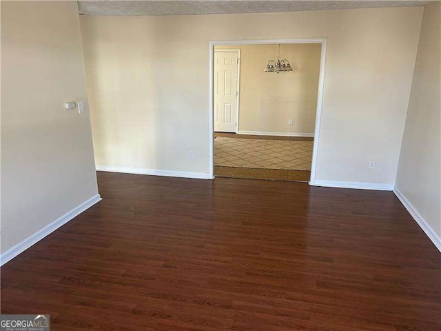 spare room featuring dark wood-type flooring