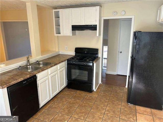 kitchen featuring sink, white cabinetry, black appliances, tile patterned floors, and kitchen peninsula