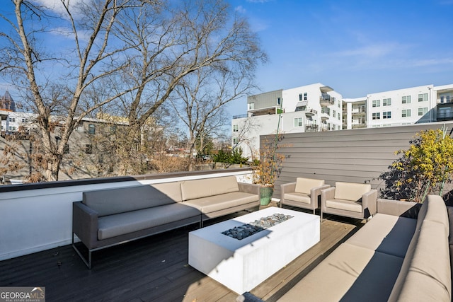 deck with an outdoor living space with a fire pit