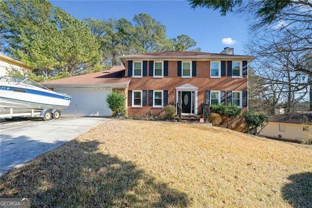 colonial house with a garage and a front lawn