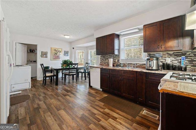 kitchen featuring sink, dark wood-type flooring, dishwasher, backsplash, and a textured ceiling