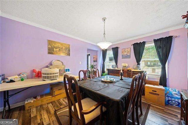 dining space with crown molding, dark hardwood / wood-style floors, and a textured ceiling