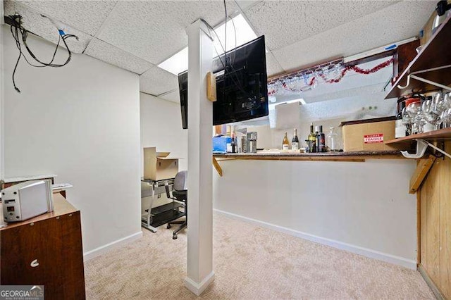 interior space featuring light carpet and a drop ceiling