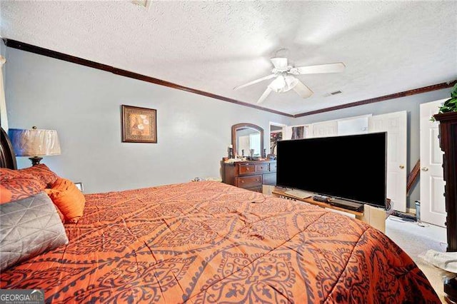 carpeted bedroom featuring ceiling fan, ornamental molding, and a textured ceiling