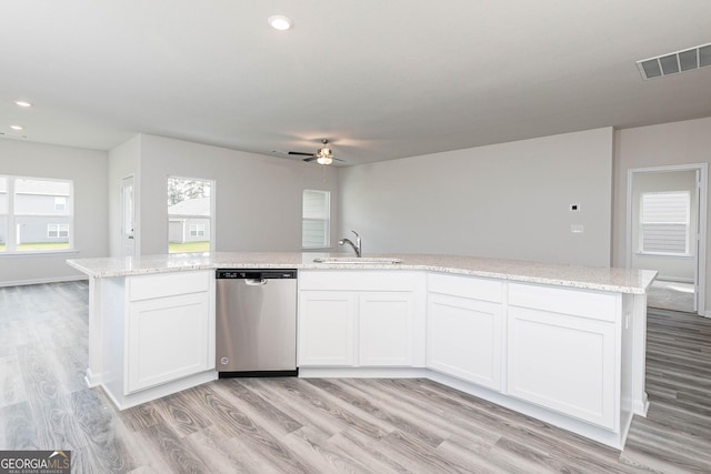 kitchen featuring sink, light hardwood / wood-style flooring, white cabinetry, a kitchen island with sink, and stainless steel dishwasher