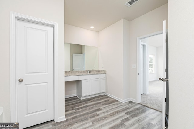 bathroom featuring vanity and wood-type flooring