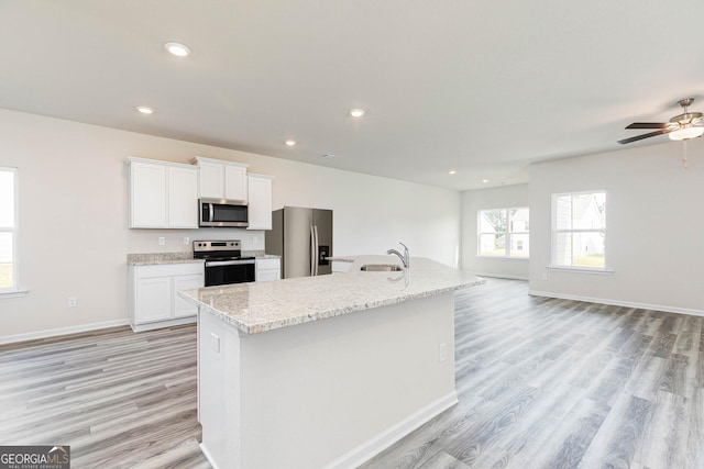 kitchen with white cabinetry, sink, a center island with sink, and appliances with stainless steel finishes