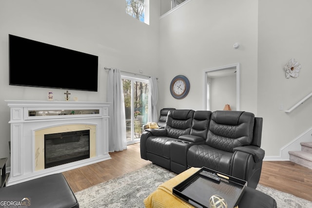 living room featuring hardwood / wood-style floors and a towering ceiling