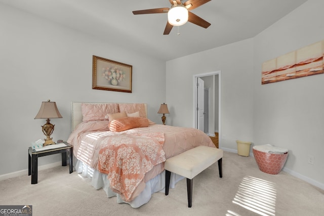 bedroom with ceiling fan and light colored carpet