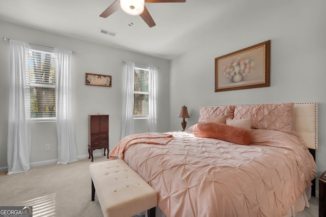 bedroom with ceiling fan and light carpet