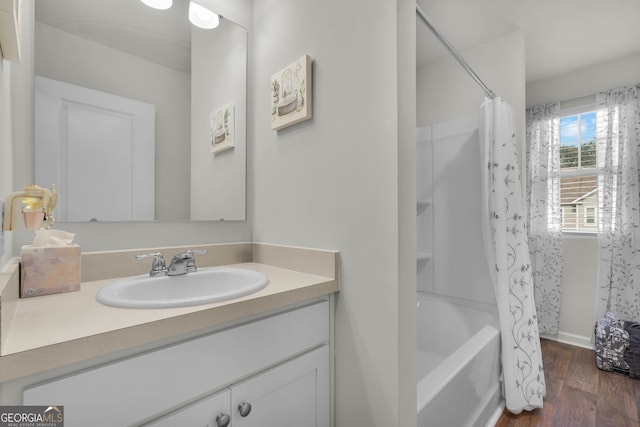 bathroom with shower / tub combo, vanity, and hardwood / wood-style flooring