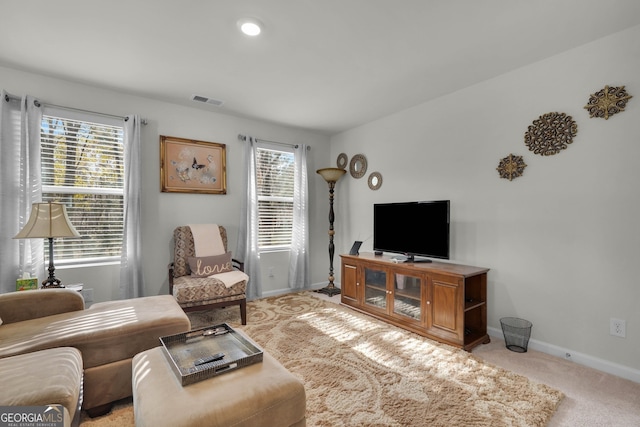 living room featuring light colored carpet and plenty of natural light