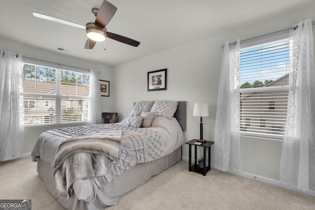 bedroom with light carpet and ceiling fan