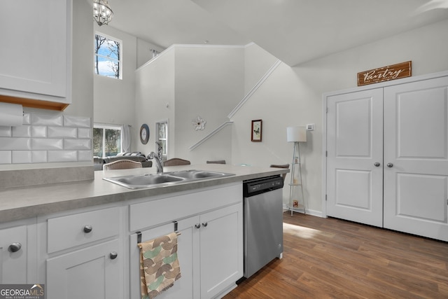 kitchen featuring white cabinetry, wood-type flooring, sink, and stainless steel dishwasher