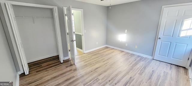 unfurnished bedroom featuring light hardwood / wood-style floors and a closet