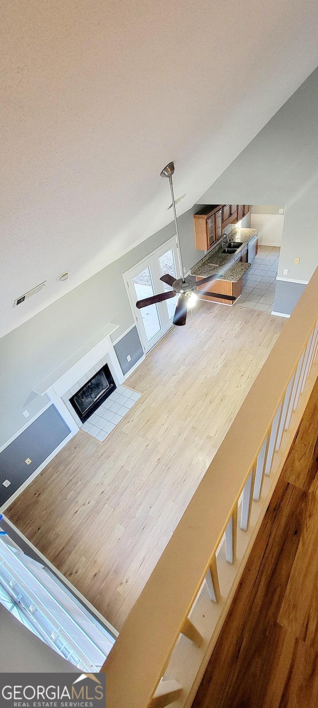 interior space featuring vaulted ceiling, sink, hardwood / wood-style floors, and ceiling fan