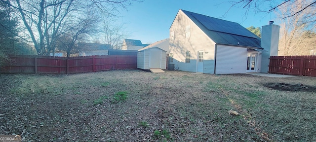 exterior space featuring a lawn and a storage unit