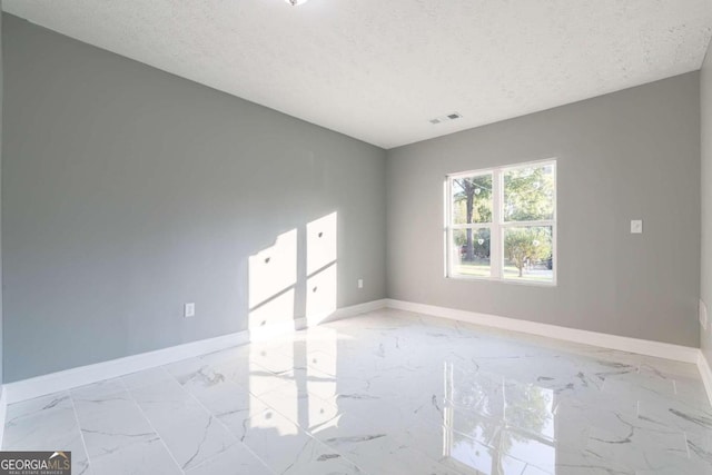 empty room featuring a textured ceiling